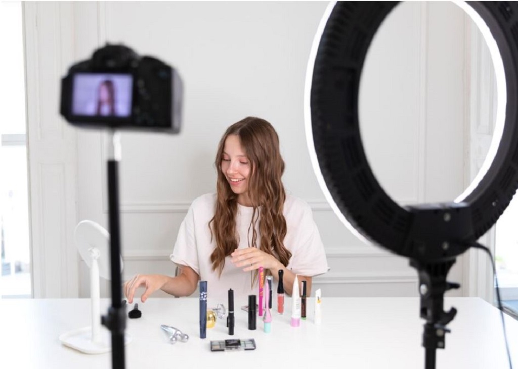 Young female social media influencer showing cosmetics