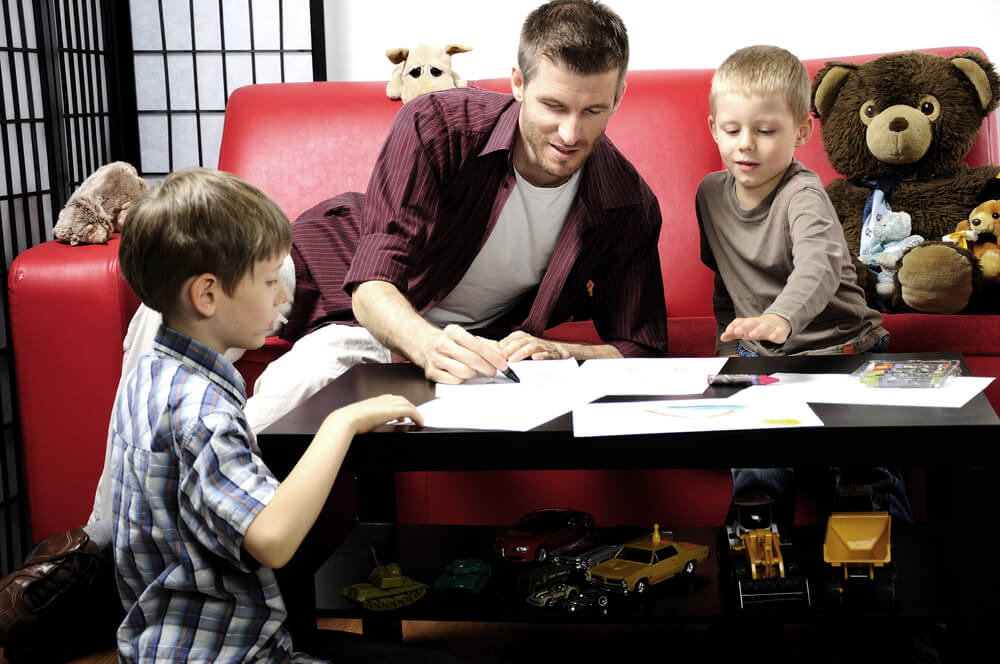Dad helping his sons study at home